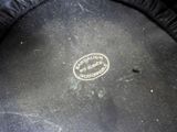a close up of a black hat with a white label on it
