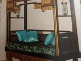 a picture of a bed with blue pillows in a room