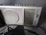 a radio sitting on top of a table next to a laptop