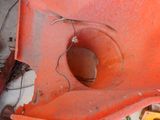 a toilet that has a hole in the side of it
