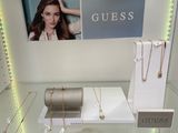 a glass display case with a bunch of jewelry on it