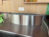 a stainless steel counter top with a metal bowl on it