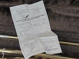 a sheet of paper sitting on top of a trumpet