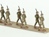 three figurines of men in military uniforms walking on a board
