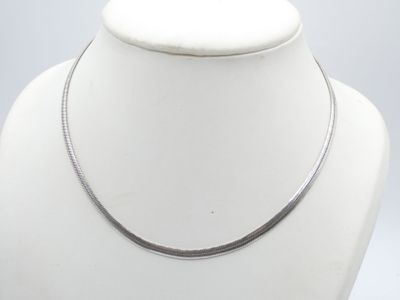 silver plated necklace on a mannequin neck with a white background
