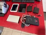 a red table with a keyboard, mouse, mouse pad, and other electronics on it