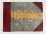 an old book with writing on it sitting on a table