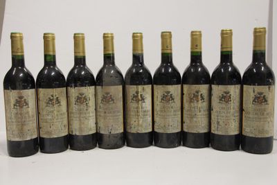 six bottles of wine are lined up in a row on a table