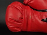 pair of red boxing gloves on a black background with copy space