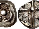 a close up of a coin with a cross on it
