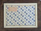 an old framed picture of a blue and white checkered pattern in a wooden frame