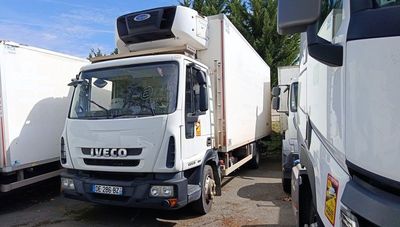 two trucks parked next to each other in a parking lot