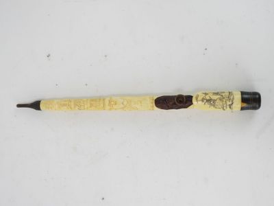 a close up of a pen on a white surface with a brown handle