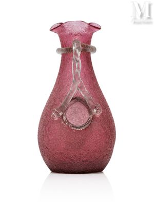 a pink vase that is sitting on a white surface