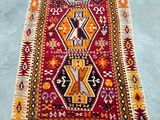 a red and yellow rug sitting on top of a blue floor