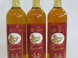 three bottles of wine sitting next to each other on a white surface