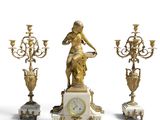 three antique clocks and a statue of a woman on a marble base