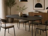 a dining table with chairs and a vase on it