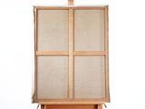 an easel with a canvas on it and a wooden stand
