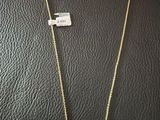 a gold necklace with a green and white bird on it
