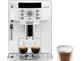 a white coffee machine with two cups of coffee next to it