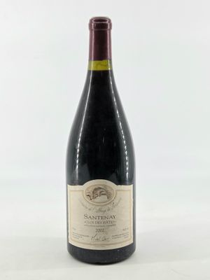 a bottle of wine sitting on top of a white table