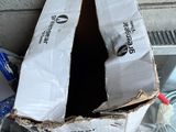 a box that is sitting in the middle of a pile of trash