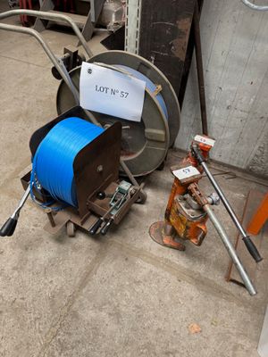 a hose and a reel on the ground next to a fire hydrant