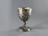 an antique silver goblet with a floral design on the rim