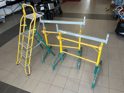 three ladders that are sitting on the floor in a store