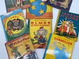 several children ' s books are sitting in a box on a table