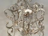 a silver chandelier hanging from the ceiling