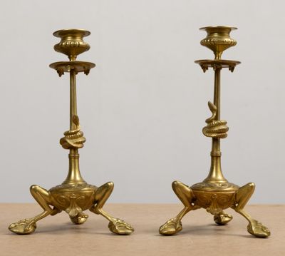 pair of antique brass candlesticks on a wooden table