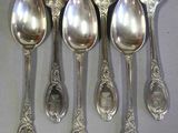 six cuillères sont alignées sur une table