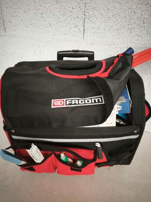 un sac de voyage noir et rouge muni d'une poignée rouge