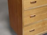 an image of a wooden chest of drawers on a grey background
