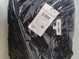 a bag of black clothing sitting on a table