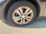 a close up of a car ' s tire on the road