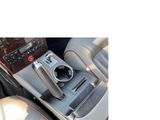 a picture of a car ' s center console with a cup holder