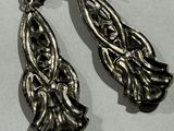 pair of antique silver earrings on a white surface