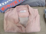 a pile of clothing that is sitting on a couch