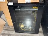 a black cabinet with a glass door in a room