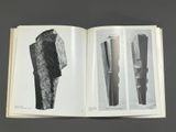 an open book with black and white images of different objects