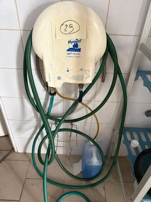 an image of a bathroom with a hose attached to the wall