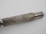 a close up of a pen on a table with a white background