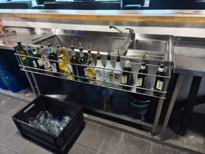 many bottles of alcohol on the counter in the kitchen
