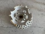a white plate with a flower on it on a marble table