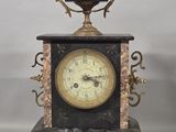 a black and gold clock sitting on top of a table