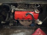an image of a car engine with a red cover