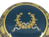 a blue and gold box with a picture of a wreath on it